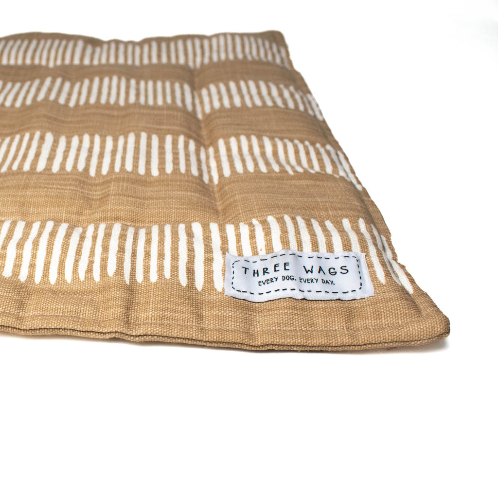 Camel colored dog mat with white dash pattern. Alternate view to show thickness.